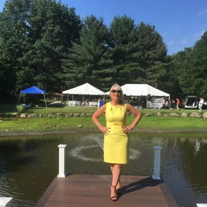 Lisa-chalfa-celebrant-lady-in-yellow-dress-on-a-boardwalk-by-river